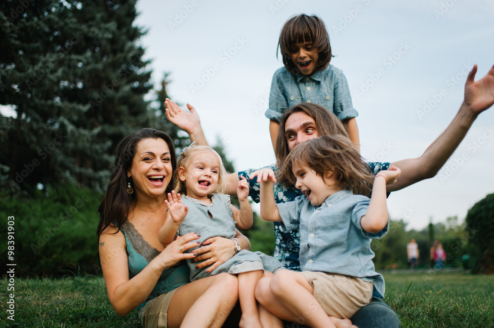 Happy young hipster family having fun, bowl, rising up, piggyback ride their children in park on summer sunset
Happy young hipster family having fun, bowl, rising up, piggyback ride their children in park on summer sunset