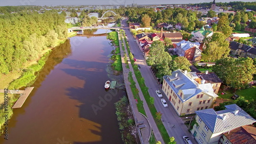 The Emajogi river on the side of the city of Tartu. The beautiful city of Tartu in Estonia with clean roads and buildings photo