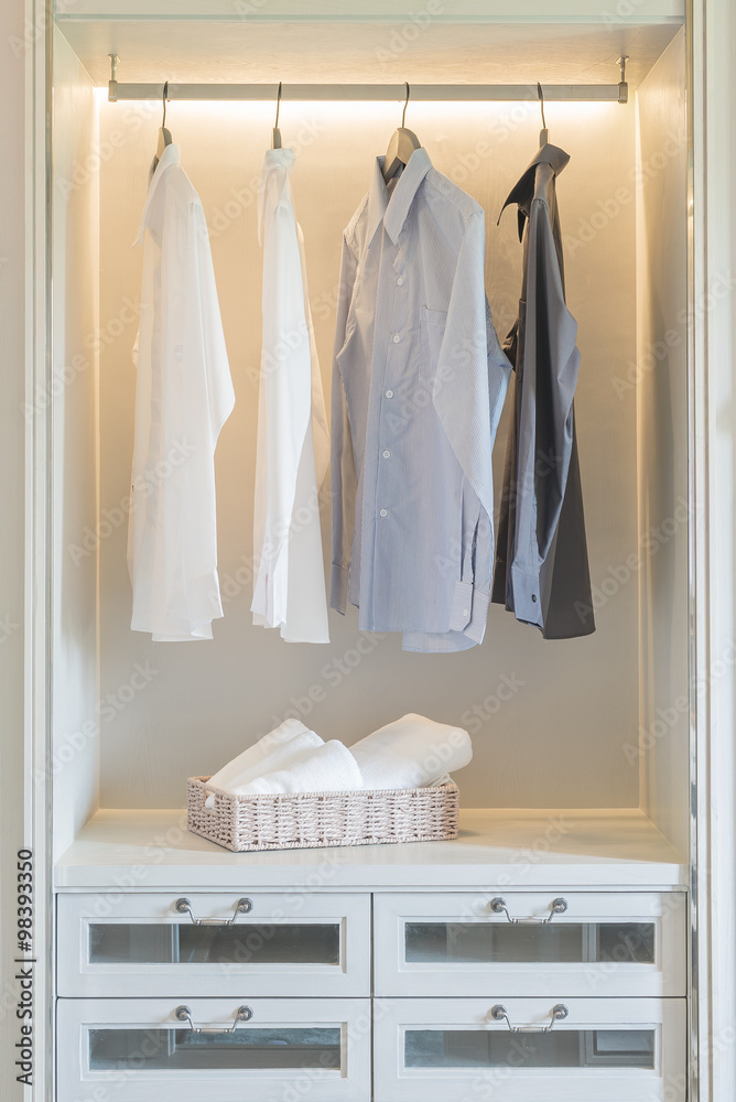 shirts hanging in white wardrobe