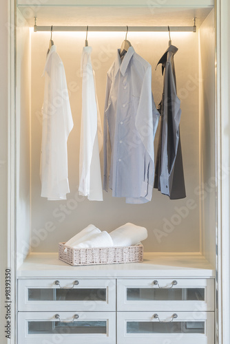 shirts hanging in white wardrobe