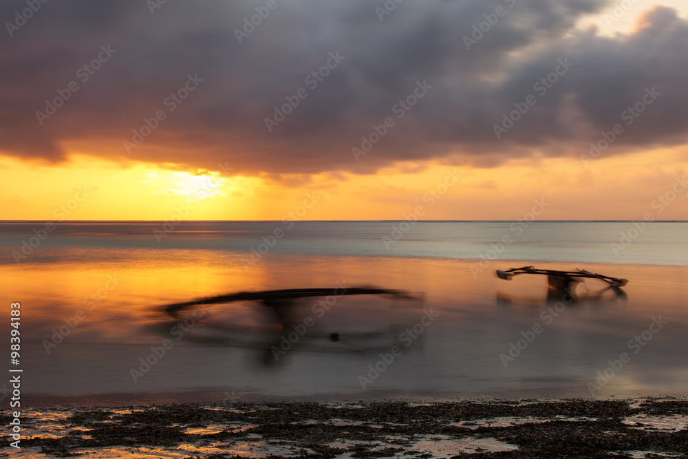 Traditional fisher boat in Zanzibar on a white beach at a beauti Traditional fisher boat in Zanzibar on a white beach at a beauti