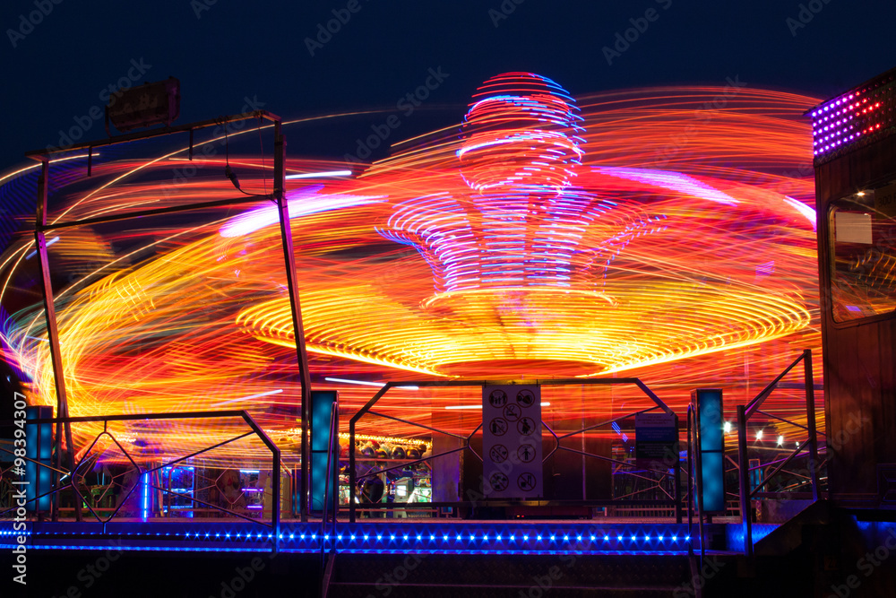 Carousels at night / The visitor amusement park, a very fun and fast carousel for adults. 