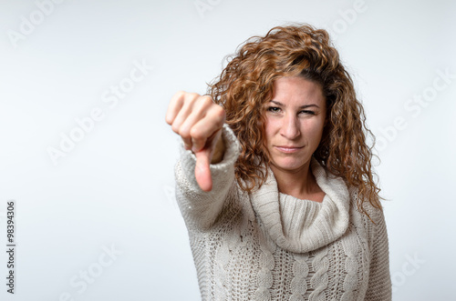 Young woman giving a thumb down gesture photo