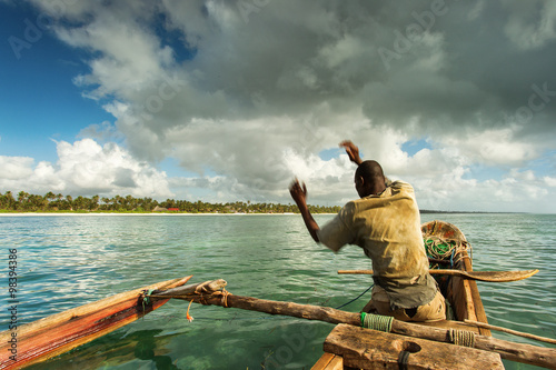 Fisherman in Zanzibar fishing in his boat on a beautiful day