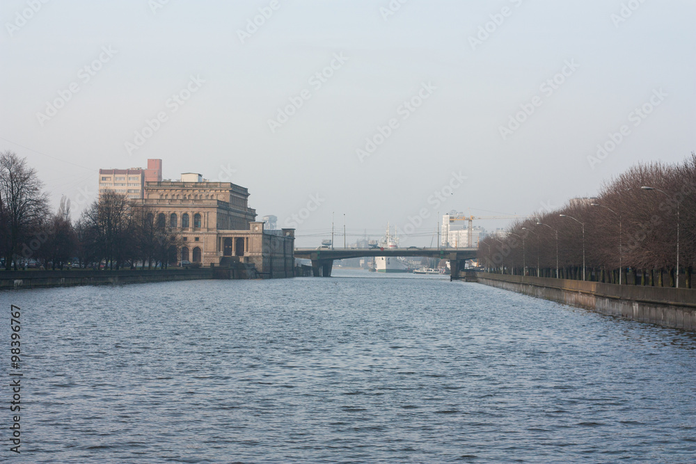 Old renovated / City landscape on the river, the house of culture of sailors and bridge. Russia, Kaliningrad. Old renovated / City landscape on the river, the house of culture of sailors and bridge. Russia, Kaliningrad.