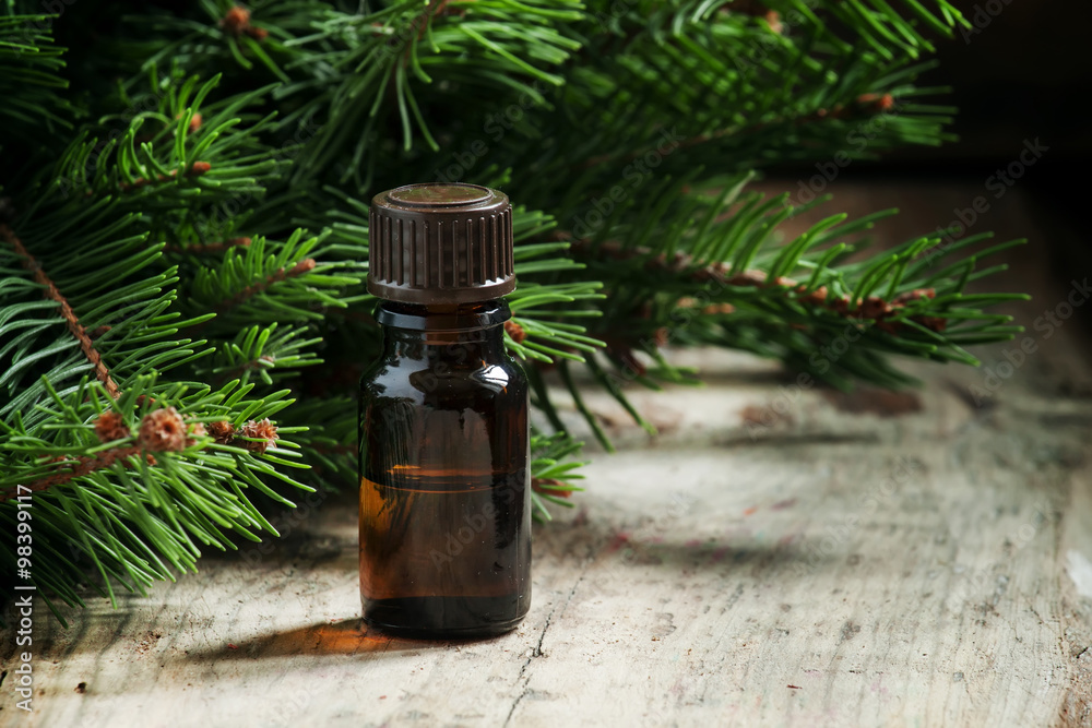 Aromatic essential ашк oil in a small bottle on the backgrou Aromatic essential ашк oil in a small bottle on the backgrou