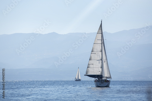 Ship yachts with white sails in the Sea. Sailing. Luxury Lifestyle.