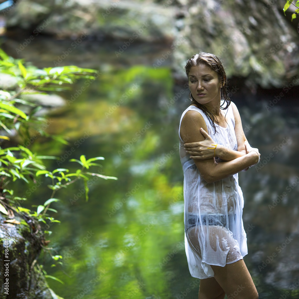 Beautiful woman outdoors standing near the pond. Beautiful woman outdoors standing near the pond.
