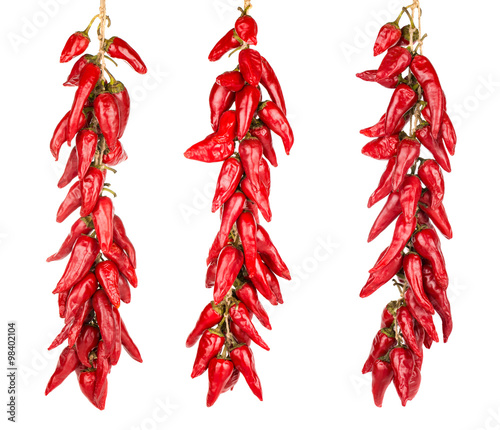 Red hot chili peppers hanging on a three ropes