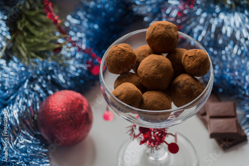 Homemade chocolate truffles on a christmas background.