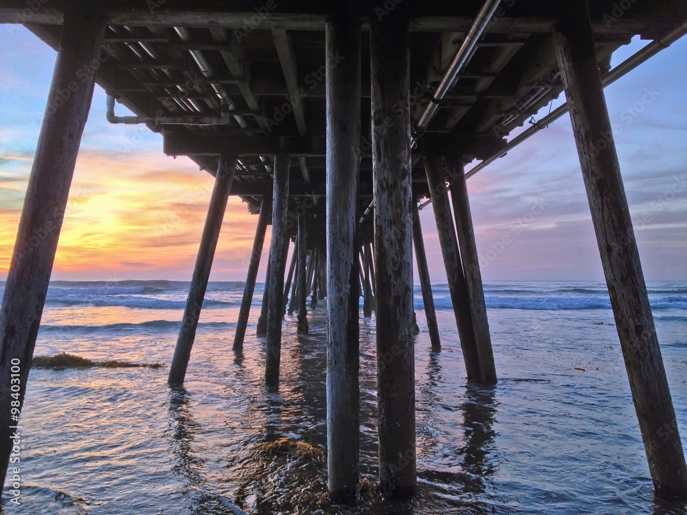 View from under beach pier at sunset, Imperial Beach, California