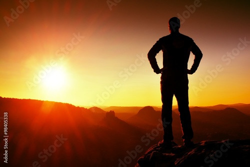 Silhouette of Young Confident and Powerful Man Standing with Hands on Hips, Morning Or Late Day Sun with Copy Space