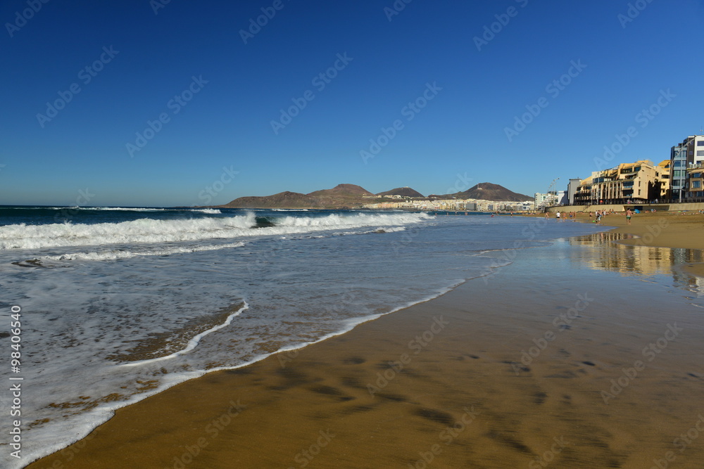 Playa De Las Canteras, Gran Canaria, Spain. Wide angle image of a popular tourism resort beach which people visit for the Winter sun.