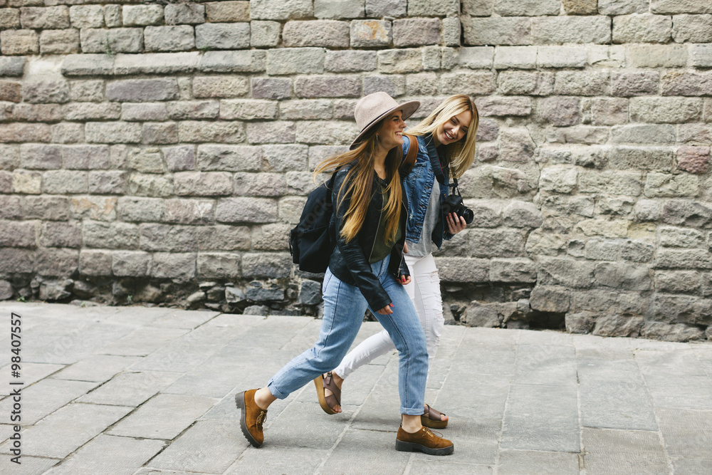 Spain, Barcelona, two young women walking in the city Spain, Barcelona, two young women walking in the city