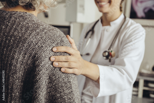 Doctor soothing senior patient