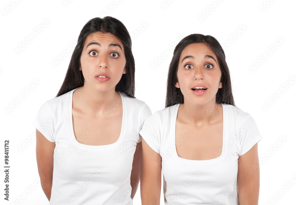 Two young surprised girls isolated