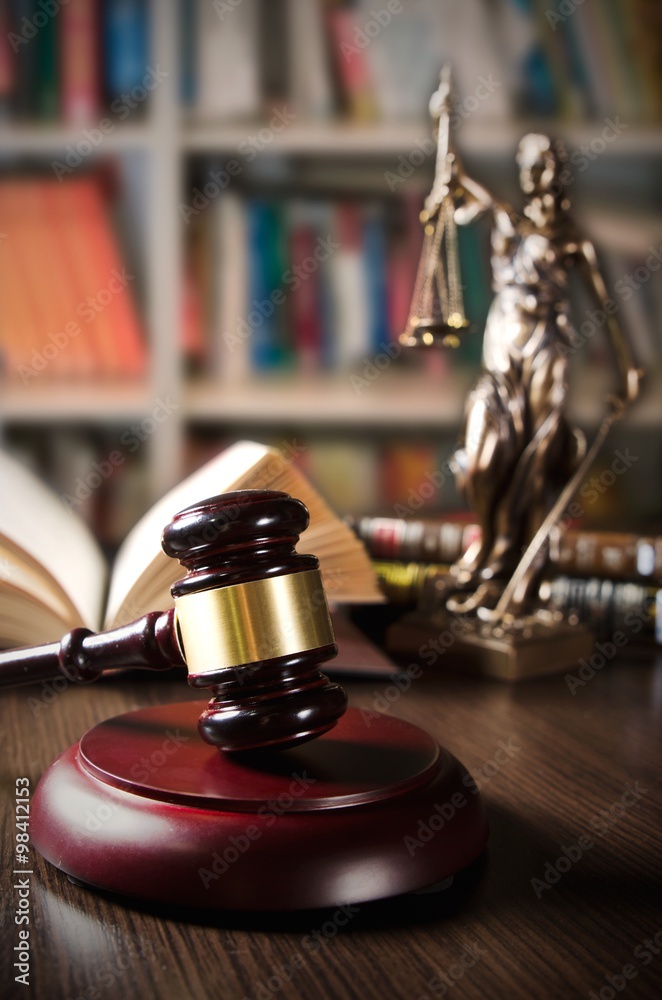 Law concept with gavel and Themis in background