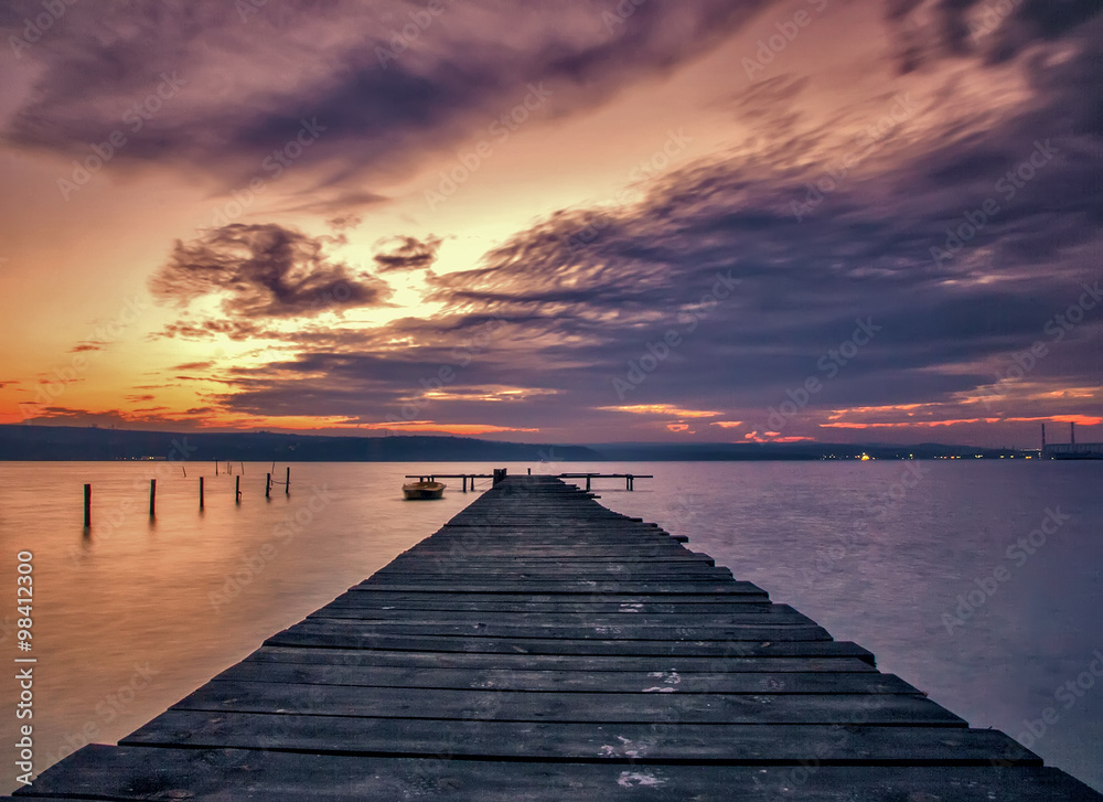 Stunning lake sunset with wooden pier