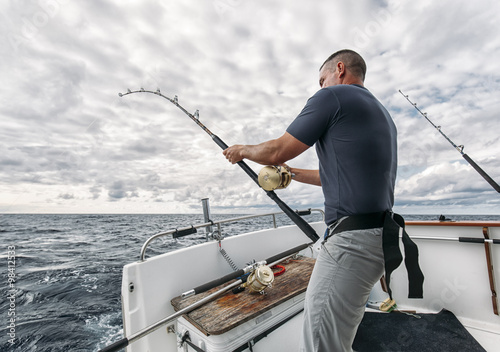 Spain, Asturias, Fisherman on fishing boat on Cantabrian Sea