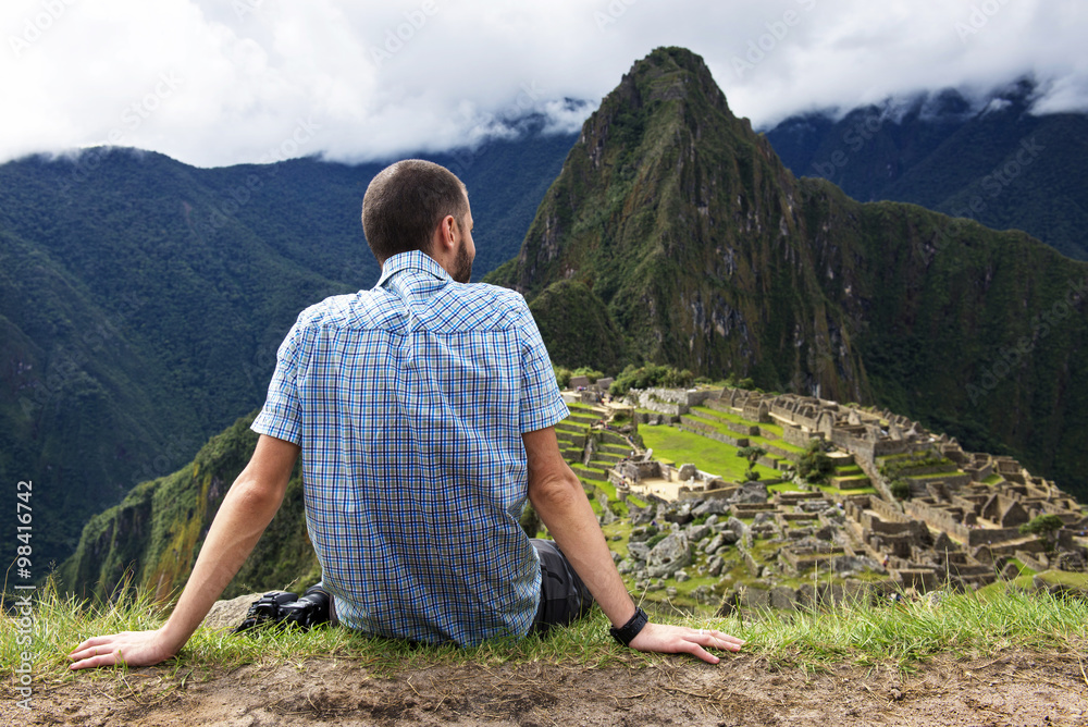 Peru, Machu Picchu region, Traveler looking at Machu Picchu citadel and Huayna mountain Peru, Machu Picchu region, Traveler looking at Machu Picchu citadel and Huayna mountain