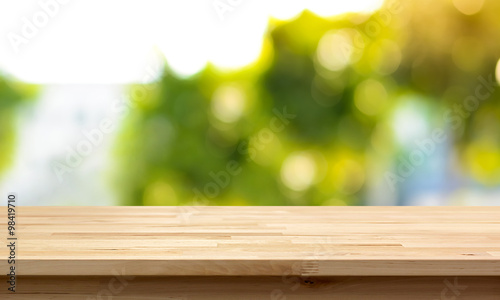 Wood table top on natural green bokeh abstract background