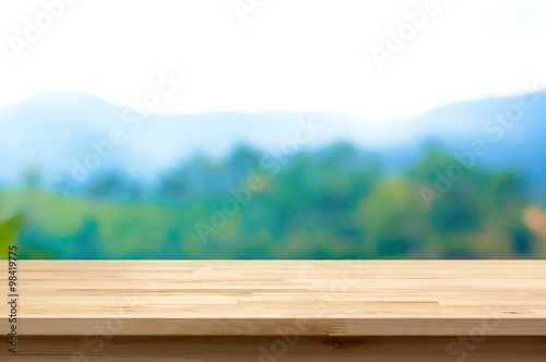 Wood table top on blur mountain background