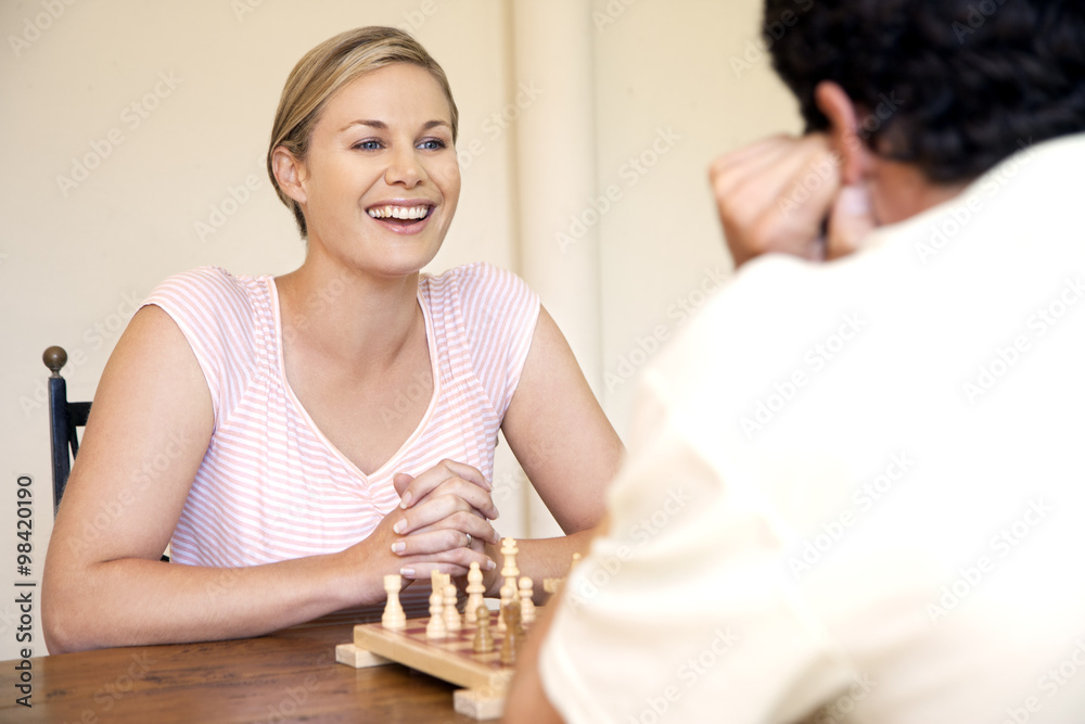 Portrait of woman playing chess with her husband Portrait of woman playing chess with her husband