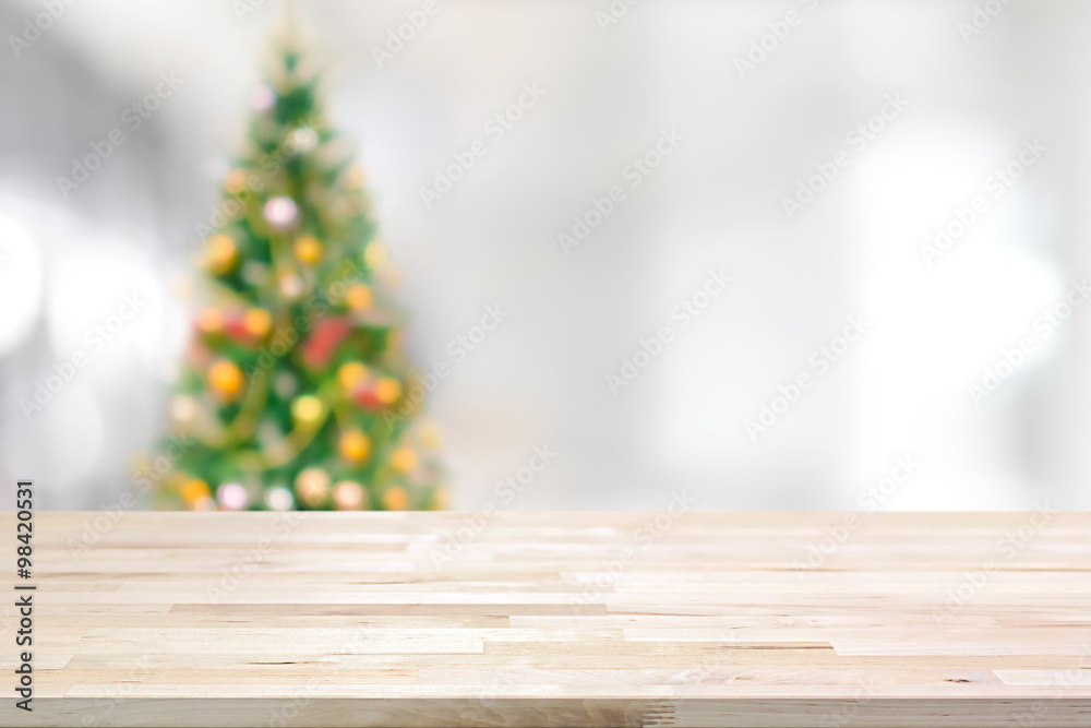 Wood table top on blur Christmas tree background Wood table top on blur Christmas tree background