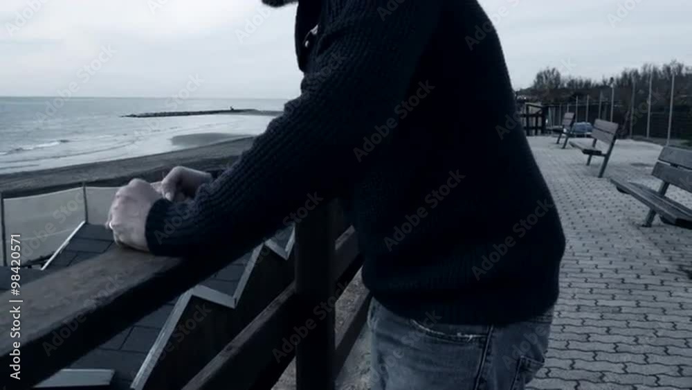 Sad lonely angry man in front of the ocean Sad lonely angry man in front of the ocean