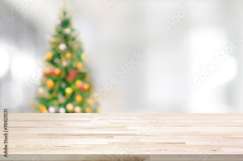 Wood table top on blur Christmas tree background