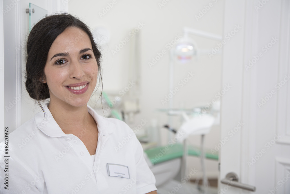 Portrait of smiling dentist at surgery Portrait of smiling dentist at surgery