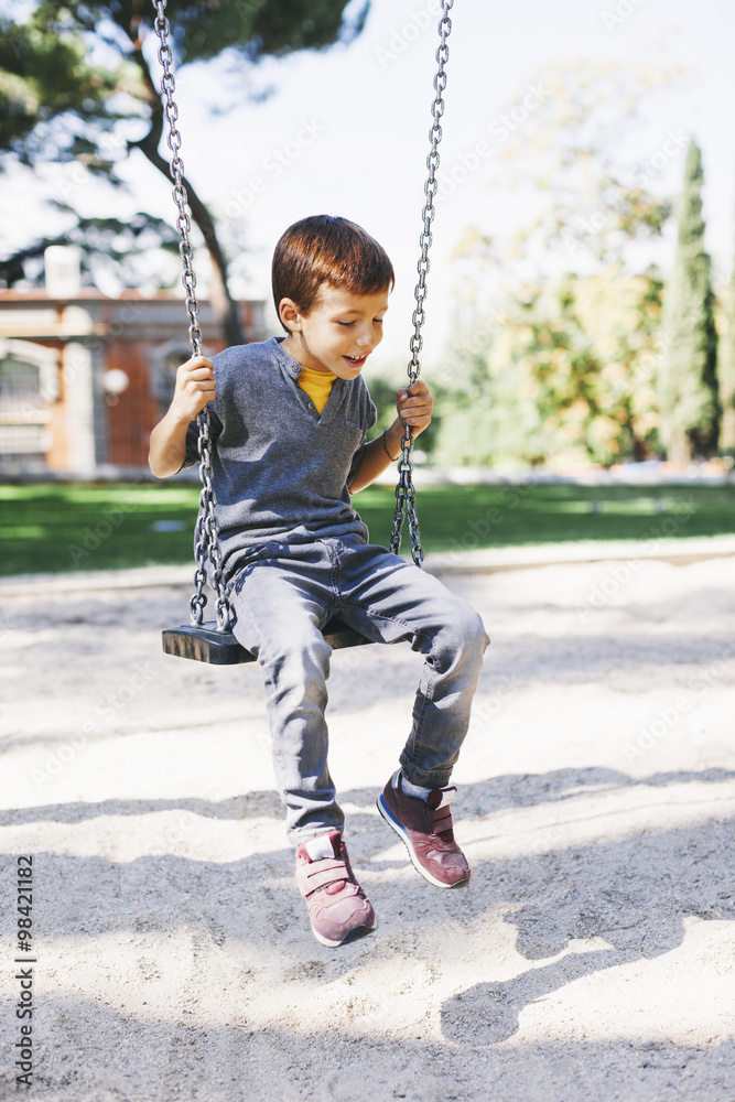 Boy on a swing at the playground Boy on a swing at the playground