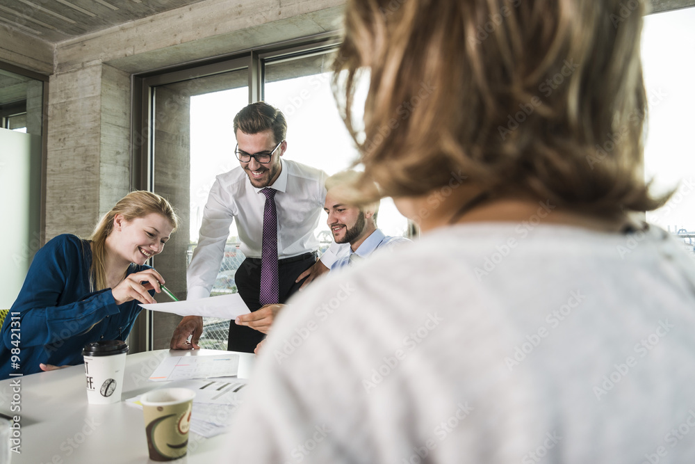 Confident business people with document in conference room Confident business people with document in conference room