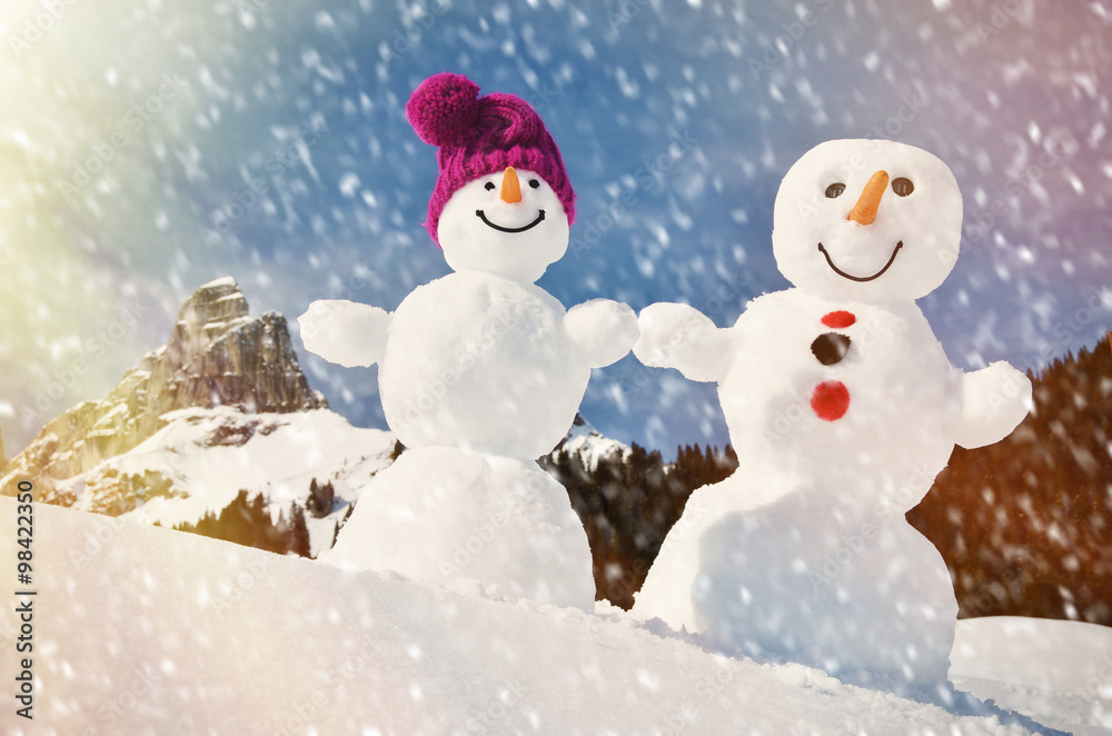 Funny snowmen against Swiss Alps Funny snowmen against Swiss Alps