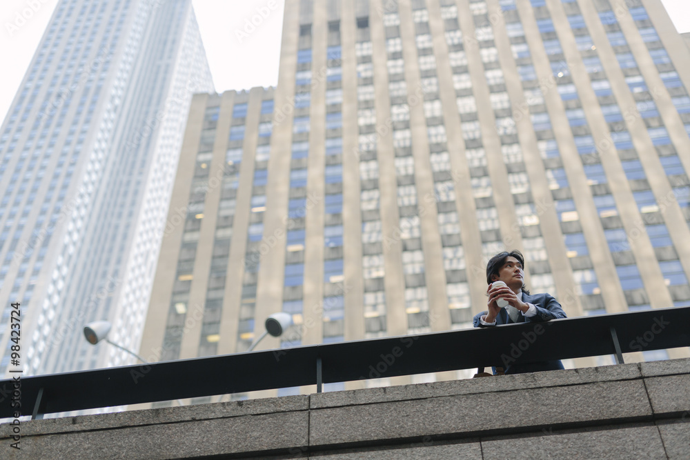 USA, New York City, businessman in front of skyscrapers in Manhattan USA, New York City, businessman in front of skyscrapers in Manhattan