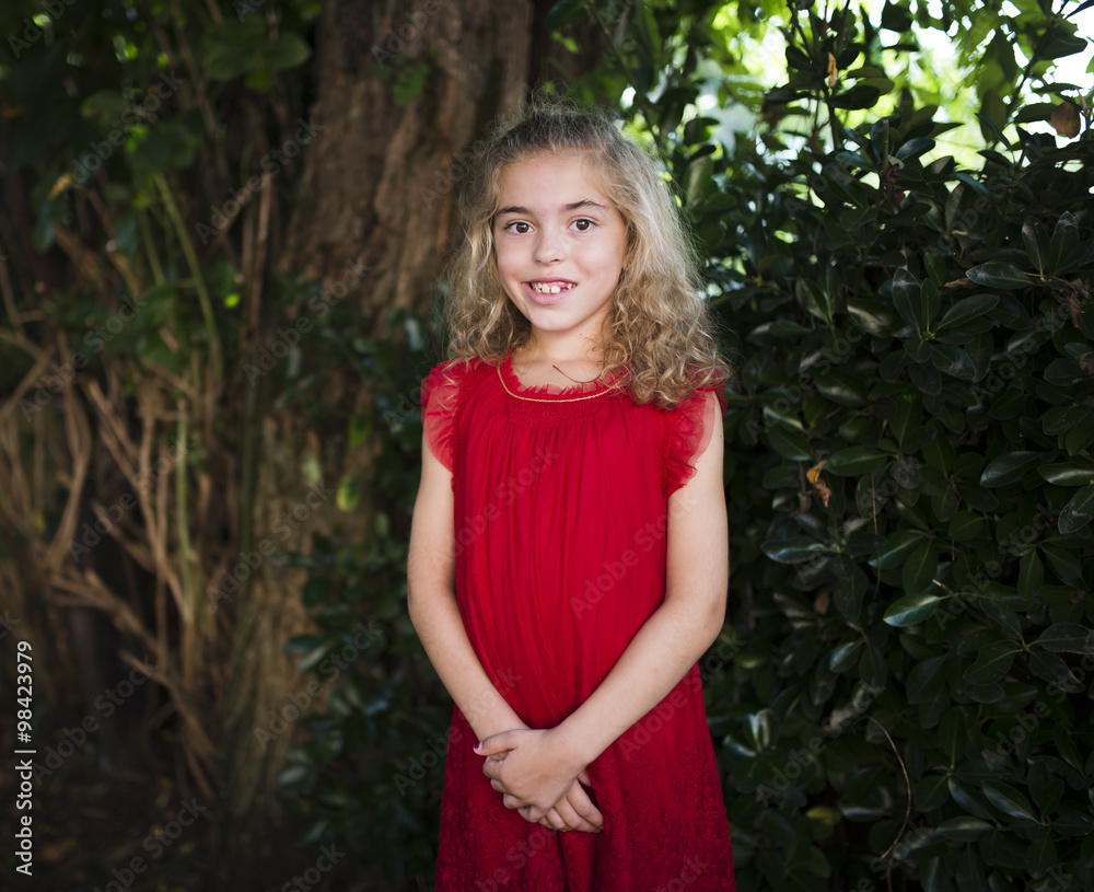 Portrait of a smiling little girl wearing a red dress Portrait of a smiling little girl wearing a red dress