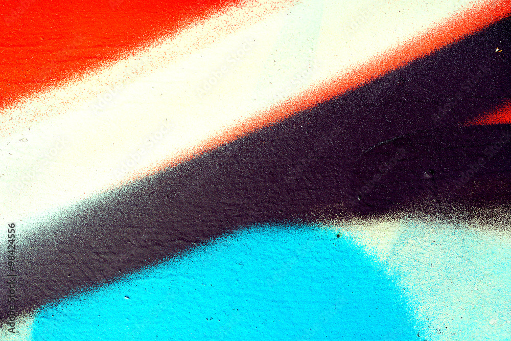 Obraz premium Brudne tło, tekstury i kolory, detal z miejskiego graffiti na ścianie pomalowanej wielobarwną farbą.