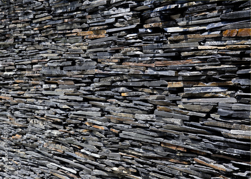 black stone wall ,pebbles , gravel backgound wall © Tazzjang