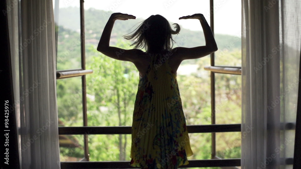 Young woman open window and admire view
