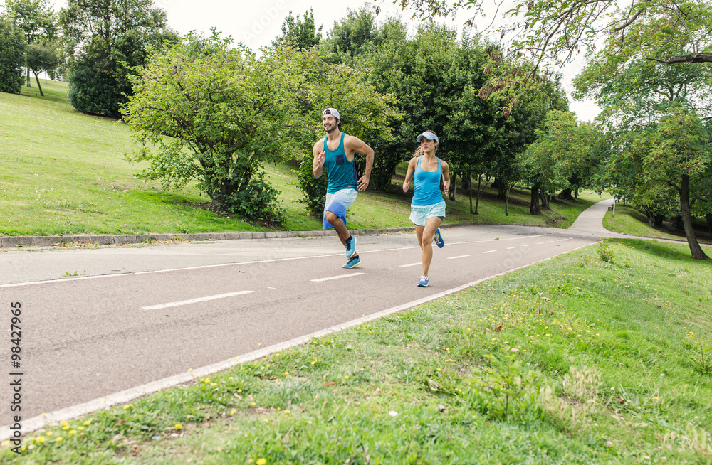 Young man and woman running in park Young man and woman running in park