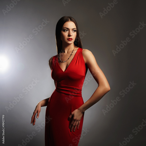 young beautiful sexy woman.Beauty brunette girl with perfect body in red dress