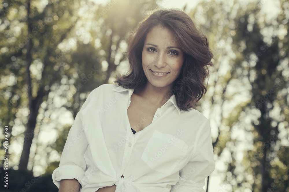 Portrait of smiling woman with brown hair in nature Portrait of smiling woman with brown hair in nature