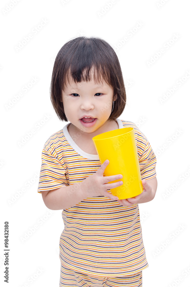 Little Asian girl holding yellow plastic glass Little Asian girl holding yellow plastic glass