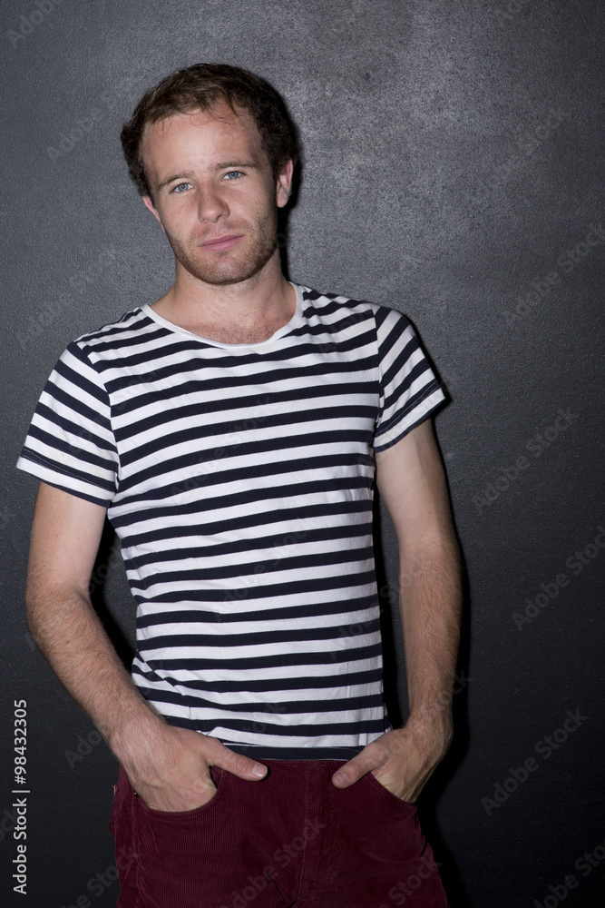 Serious young man, black-and-white striped shirt Serious young man, black-and-white striped shirt