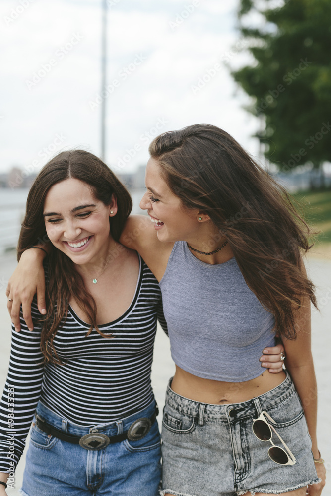 USA, New York City, two happy friends walking outdoors USA, New York City, two happy friends walking outdoors