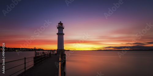 UK, Scotland, Edinburgh, Newhaven Harbour with lighthouse at sunset photo