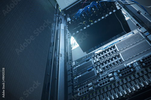 Bottom view of rack server against neon light flare in datacente photo