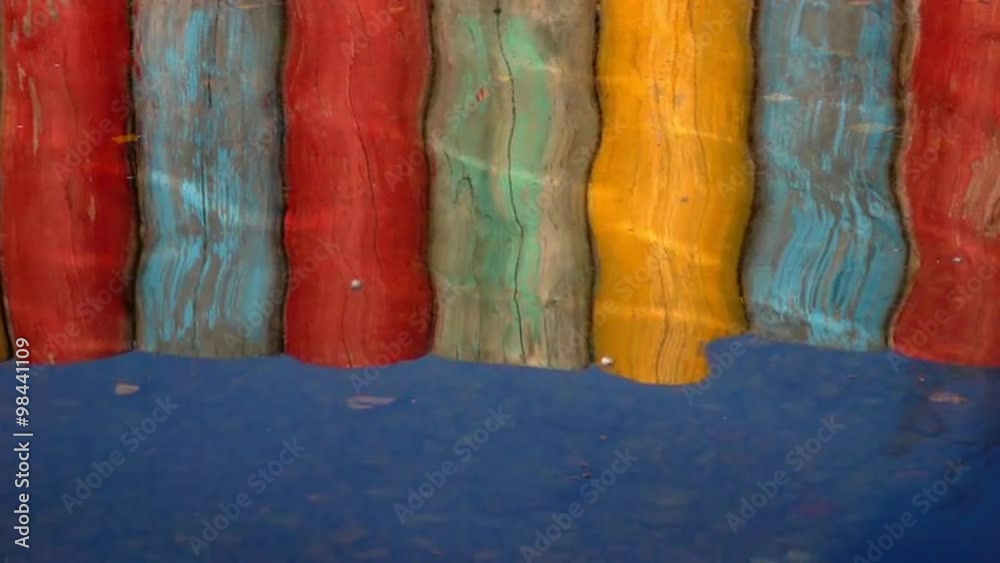 custom made wallpaper toronto digitalSlow motion reflections of colorful pier in the water with play of sun. Attractive moving background with meditative and hypnotic effect. Relaxing view of the calm water. Full HD footage 1920x1080.
