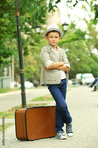 Little boy with suitcase in...