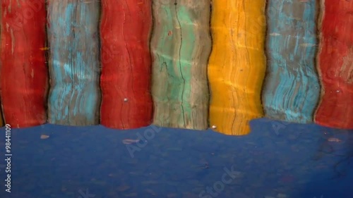 Wallpaper Mural Slow motion reflections of colorful pier in the water with play of sun. Attractive moving background with meditative and hypnotic effect. Relaxing view of the calm water. Full HD footage 1920x1080.
 Torontodigital.ca